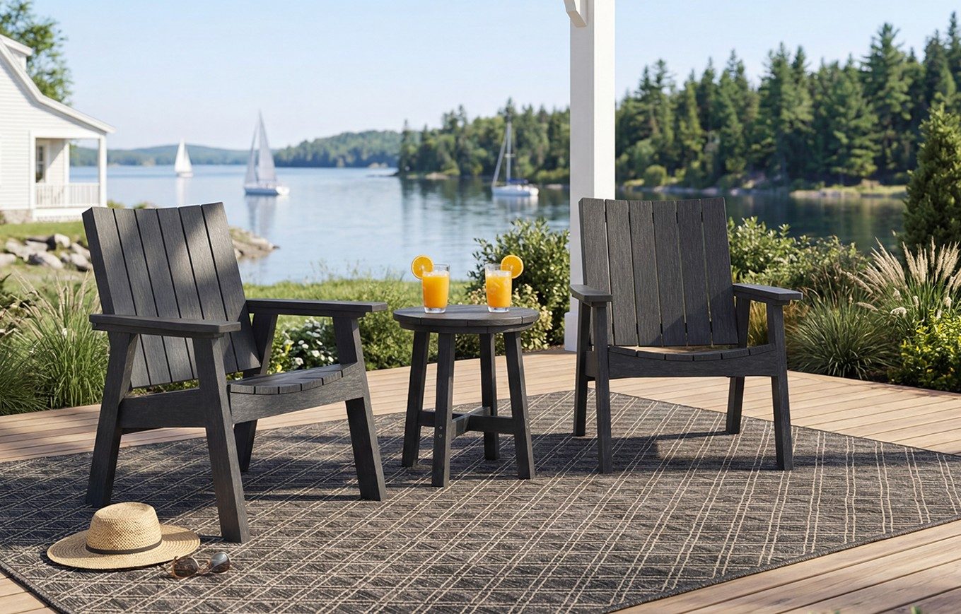 Two black C41 Chat Chairs and a T02 Round Side Table on a lakeside deck