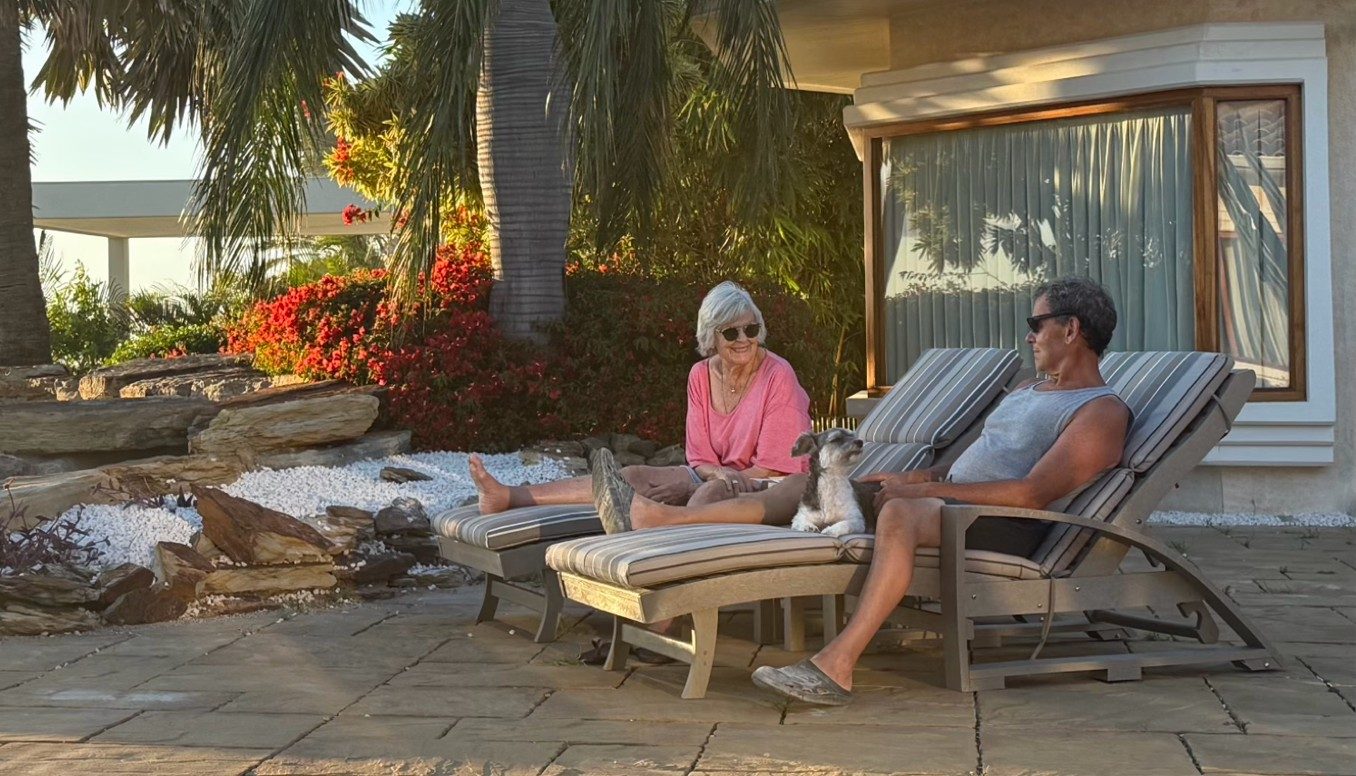 Couple relaxing on L38 Ellen Lounges on a garden patio