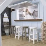 4 Barstools beside a build in surf themed bar