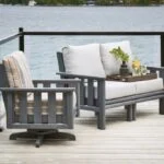 Stratford Swivel Armchair and Stratford Deep Seating Loveseat on a dock beside a lake