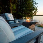 Two Charleston Swivel Armchairs overlooking the lake with a Round Fire Table