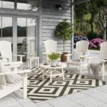 C03 Upright Adirondacks in White with Side tables and Cocktail table on a backyard patio