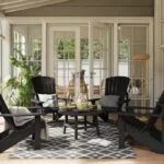 C01 Classic Adirondack Muskoka Chairs around a TB01-TT03 Cocktail Table in Black on a stylish backyard patio