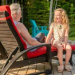 L99 Ellen Lounge Chair in black with a multigenerational family - grandma and granddaughter enjoying quality time together