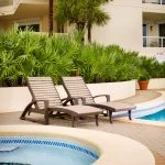 L99 Ellen Lounge Chairs poolside at a hotel in Two Tone Beige-Chocolate